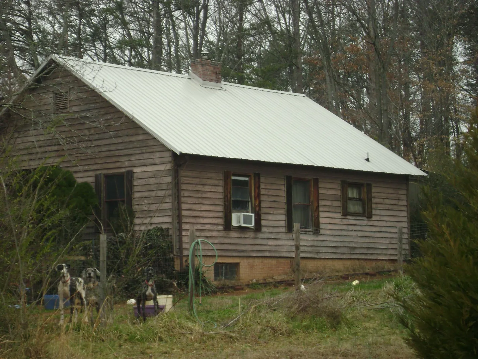White metal roof on an old wood sided farmhouse, from a Metal Roof Installation job in Montezuma